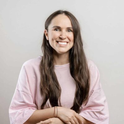 Brunette girl with long hair on a gray background